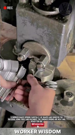 spoon manufacturing process: a worker is forming and smoothing a spoon using a press or lathe