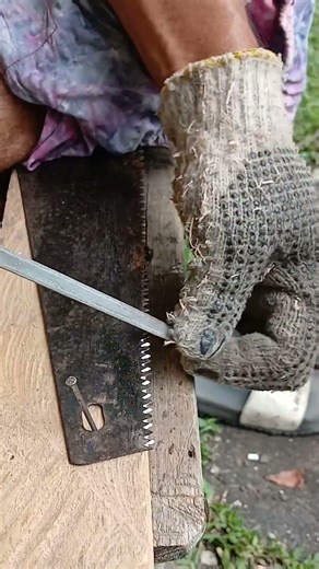 sharpening a hand saw blade using a triangular file,,#handsaw,,,