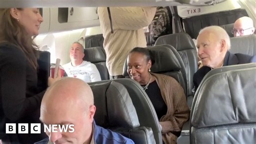 Biden takes selfies with passengers as he takes commercial flight