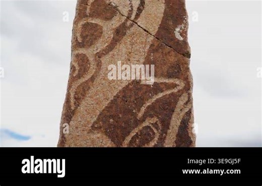 Asian deer stone monument bears ritual symbols on an ancient burial stele in open steppe. Archaic balbal marker and carved menhir express funerary belief, nomadic heritage, and worship. carving, sculpture, obelisk, inscription Stock Video Footage - Alamy