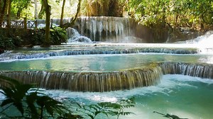 Natural scenery of beautiful Erawan waterfalls in a tropical rainforest environment and clear emerald water. Amazing nature for adventurers Erawan National Park, Thailand