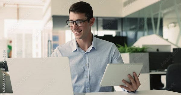 Multitasking, efficient workflow management. Employee, businessman using laptop and tablet to enhance productivity, using business app on multiple devices, prepare tasks, check trends and stockmarket