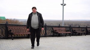 clip-1039481036-confident-fat-man-looking-camera-walking-city