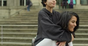 MS Woman giving girlfriend piggyback ride