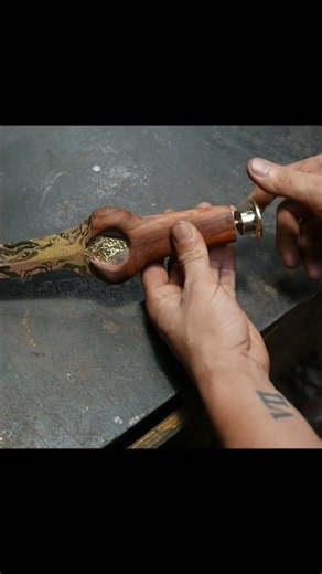 Fabricating a Damascus copper knife bolster component.