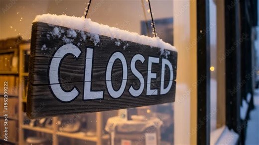 Closed sign, weathered wood, hangs on snowy shop window. Fresh snow covers sign top, camera rotates right, revealing temporary closure message. Concept closed sign for small business,