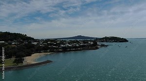 Devonport, Auckland / New Zealand - December 11, 2019: The Victorian Style Seaside Village of Devonport, with the skyline of Auckland’s landmarks and CBD in the background