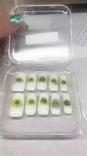 Gaze into the cosmos. The Astral Eye set is a mesmerizing fusion of celestial mystery and modern nail artistry. Using a specialized blooming gel technique, the deep black and vibrant green pigments melt together to create an organic, iris-like effect that looks like a nebula trapped in glass. At the heart of each