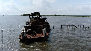 Tug Boat Wreckage in the Water on Lake Lake Pontchartrain Day time Drone Shot panning right