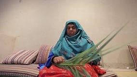 An Elderly Arab Women in Traditional Colorful Clothes Sews Local Clothes Stock Video - Video of asia, group: 160812465