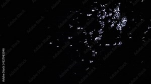 Real frost on a window. Frostwork pattern ice crystals on black background. Dark surface with abstract ice structure makes to overlay or add a frost effect.