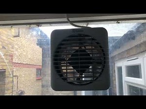 The Xpelair GXC6 kitchen window fan turned on with the shutters open
