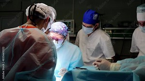 High-tech hospital dedicated group of surgeons and assistants carry out complex life-saving procedure. Hard work of surgical team perform crucial operation modern microsurgery in hospital.
