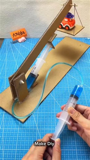 Kusum Verma on Instagram: "Syringe Se Car Lift?! 😱 | DIY Hydraulic Lift Science Experiment | Cardboard Project Have you ever seen a car lift made using syringes? 😲 In this video, I made a DIY hydraulic car lift using cardboard, syringes, tubes, and water. This is a fun and easy science experiment that shows how hydraulic pressure works in real life. Perfect project for: ✔️ School science project ✔️ Physics experiment ✔️ DIY cardboard ideas ✔️ Hydraulic system working model Try this at home and