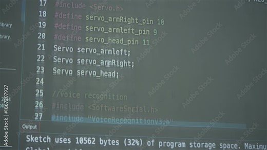 Close-up of a monitor showing Arduino IDE code with speech command function for a robotics or IoT programming project.