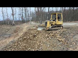 Leveling piles of dirt with the D3 CAT dozer.
