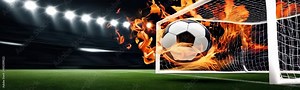 soccer Ball on Fire Burning against net in a stadium under bright spotlights. Football sport competition copy space background
