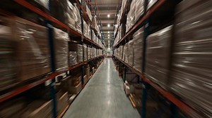 Fast drone FPV flight in logistic center. Speed motion view of industrial storage with racks full of delivery goods. Retail warehouse.