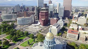 Aerial Drone tilt reveal of the Colorado state capital government building with the skyline of Downtown Denver Colorado in the background. - Denver , Colorado , USA