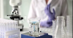 Transparent liquid water in glass flask and magnetic water purification. Laboratory and chemical analysis of water
