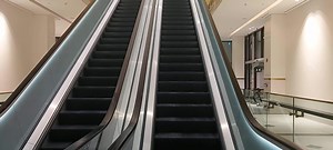 Download Slowmoving empty elevator stairs shop mall,stairs elevator with glass railling and shiny metal moving up and down for free
