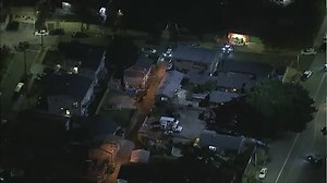 Three LA police officers shot, suspect barricaded