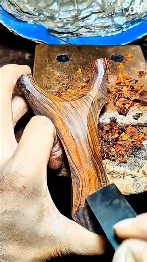 Hand sanding reveals rich grain on crafted wood piec