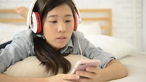 Young Girl Using Mobile Phone On Stock Footage Video (100% Royalty-free) 1015069873 | Shutterstock