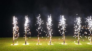 Fireworks fountains sparkling at night during outdoor celebration