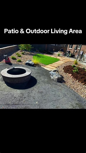 🌿 Landscape Design Behind the seating area is a modern xeriscape backyard that includes: \t•\tA curved artificial turf lawn section for greenery and contrast \t•\tDecorative landscape rock surrounding planting beds \t•\tLarge accent boulders placed naturally in the yard \t•\tOrnamental grasses and shrubs planted throughout \t•\tA natural stone stepping-stone walkway leading from the fire pit to the patio. #patio #firepit #artificialgrass #landscapedesignbuild #landscape