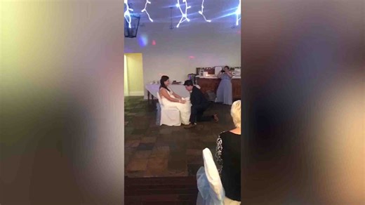 Groom's funny surprise during garter toss for pregnant wife