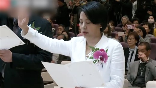 China-born lawmaker takes office, faces questions about loyalty