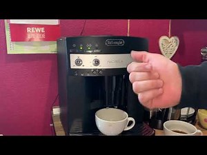 Adjusting the grinder De'Longhi Magnifica ESAM 3000.B fully automatic coffee machine operating in...