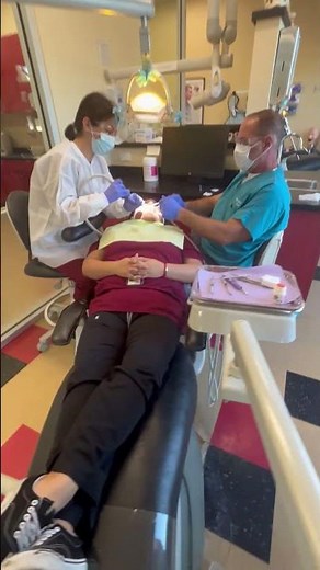 Dental Assisting Student Providing Chairside Assistance to a Dentist