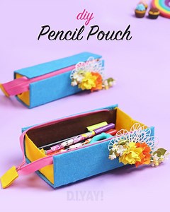 Pencil Pouch | Organizer Pouch | Back To School Supplies Needed: Felt Sheet Cardboard Scissors Glue gun Zip Ruler Decorative Flowers Getting zippy with this DIY Pencil Pouch Organizer flat bottom design. This DIY is super similar to the basic zipper pouch, but has a flat bottom so it can stand up! We all love a pencil box that stands up while I grab stuff out of it. That flat bottom design makes the zippered pouch feel bigger and hold bigger bottles and containers a little bit better. Creating t