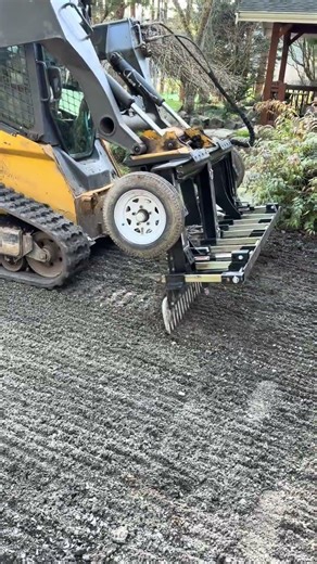 Driveway needed to drop about an inch, using the landscape rake to pull material back! #construction
