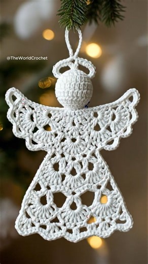 This delicate crochet angel is being hung on the Christmas tree, adding the sweetest handmade touch to holiday decor 🎄✨ #crochet #crochetangel #crochetchristmas #christmasornament #handmadeholiday #crochetdecor | Theworldcrochet