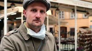 Angry man with phone, outdoors. Unwanted ads pop up and interrupting phone calls. When download certain apps, they sometimes push annoying ads to the smartphone.