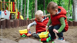 Two children playing in sandbox