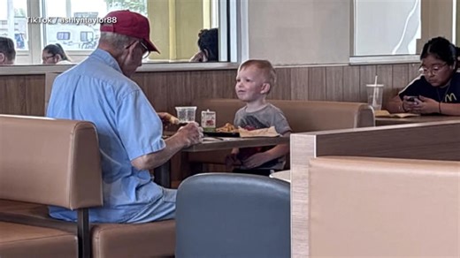 Little boy keeps veteran company at breakfast
