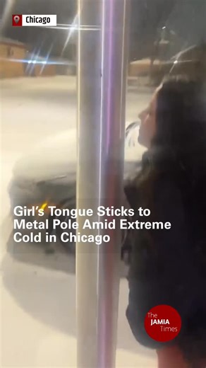 The Jamia Times on Instagram: "A video circulating online shows a young woman’s tongue becoming stuck to a metal pole in Chicago during freezing temperatures, highlighting the dangers of exposed metal in extreme cold. The incident occurred as parts of the US Midwest experienced severe winter conditions, with experts warning that contact with metal surfaces can cause skin to freeze instantly, leading to serious injury. Authorities have urged people to limit exposure outdoors and take precautions