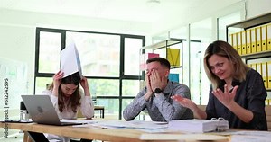 Frustrated frustrated people from business team are studying negative business statistics. Sad people due to poor performance frustrated by corporate bankruptcy crisis