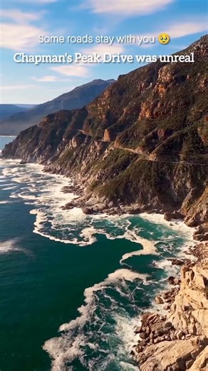 Bhumika Patil 🧿 on Instagram: "Have we just found one of the most beautiful roads in the world? 🇿🇦 Chapman's peak Drive runs along the base of Chapman’s Peak, surrounded by dramatic cliffs and coastal views. A quiet stretch that captures the raw beauty of Cape Town’s natural landscape. { Chapmans Peak, Chapmans Peak Drive, Cape Town, Cape Town Scenery, Vacation , Travel Destination, Honeymoon Destination, Travel To South Africa, Scenic Route, Coastal Road, Cape Town Roads, Mountain Views, Exp