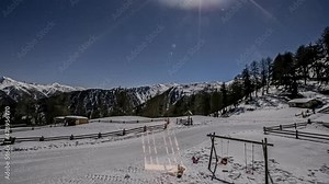 Time - lapse of the sun shadow moving down towards the white mountains and becoming a dark night with the climate change. Stock Video