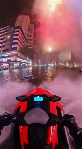 Riding a Jet Ski Through City During New Year Fireworks