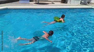 Happy children pool fun splash water happy summer kids splashing in pool kids holiday summer travel fun boy. Cheerful children swimming pool playing water kids swimming boy water fun summer vacation