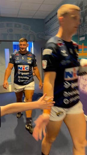 The boys head out for the warm with a high-five for the mascot who’s already kitted out in our new MND charity shirt.
