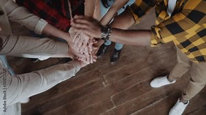 Teamwork success, office workers fold their hands celebrating the launch of a new project. Business group, teamwork in office, team building, people lifestyle, coworking space.