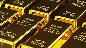 Gold bars stacked in a row. Gold bricks. Stack of gold bullion bars. Seamless looping footage. The camera pans around gold bars in close up.