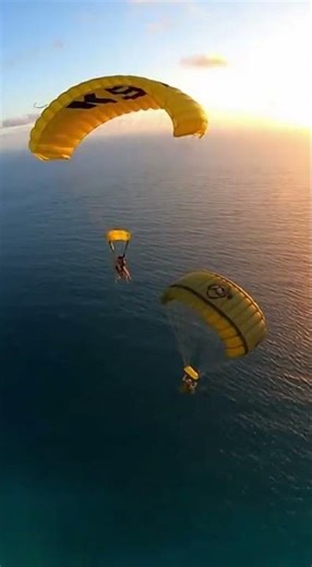 Large military transport aircraft flying above deep ocean near coastline Cargo ramp opens The dog